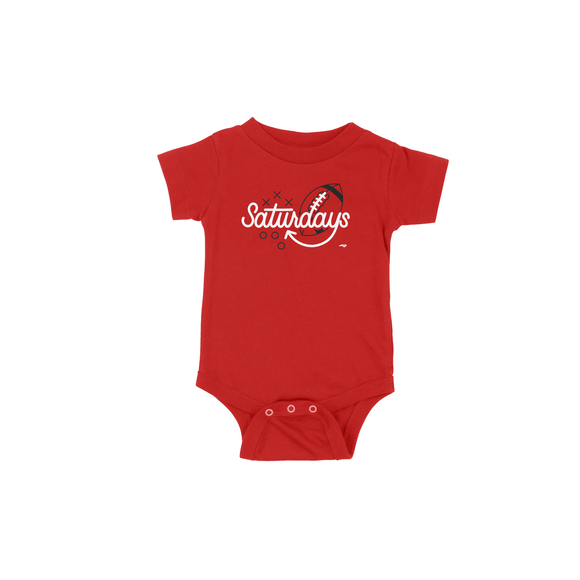 Red onesie with the word Saturdays in white and black football behind the letters D A Y S