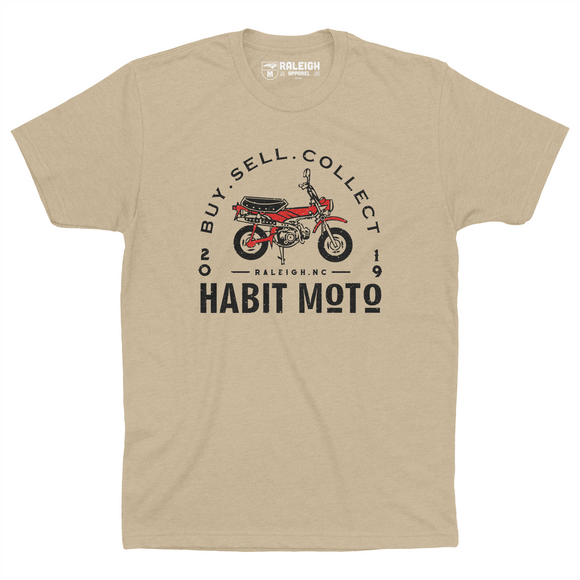 Cream colored Habit Moto shirt with orange motorcycle on chest. Has arch around motorcycle that says "buy, sell, collect". 