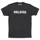 Charcoal colored t-shirt that says Raleigh in white capital letters across the chest. 
