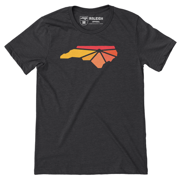 Charcoal colored t-shirt with Raleigh Apparel logo on chest in warm colors. 