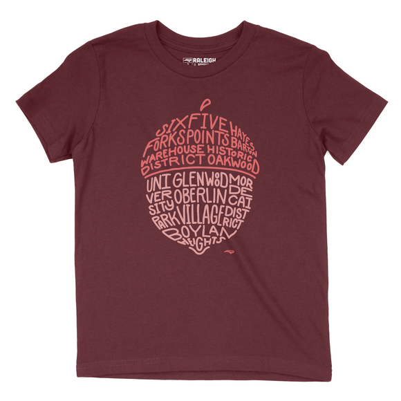 Maroon colored youth t-shirt with salmon colored acorn on chest that spells out different neighborhoods in Raleigh.