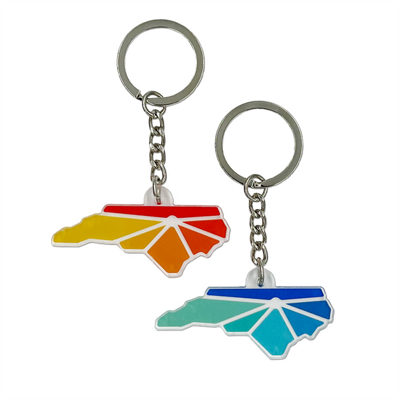 Key chains with Raleigh Apparel logo. One in warm colors, one in cool colors